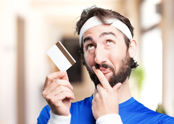 Crazy sports man with credit card — Stock Photo, Image