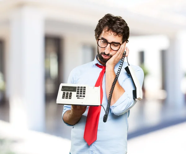 Gek zakenman met oude telefoon — Stockfoto