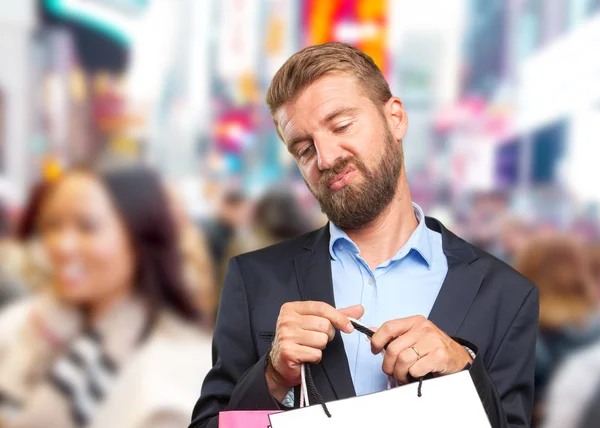 Hombre de negocios rubio con bolsas de compras —  Fotos de Stock