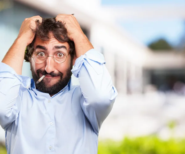 Crazy hippie man smoking a cigarette — Stock Photo, Image