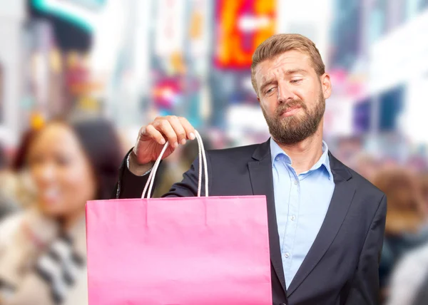 Hombre de negocios rubio con bolsa de compras —  Fotos de Stock