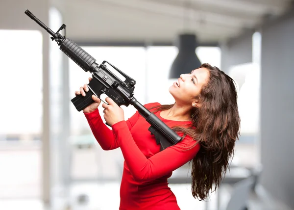 Young black girl with gun — Stock Photo, Image