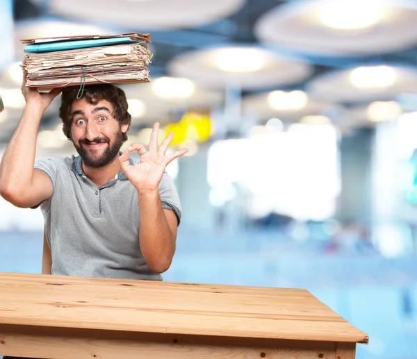 Crazy young man at table with documents — Stock Photo, Image