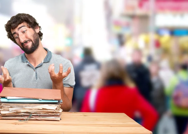 crazy young man at table with documents