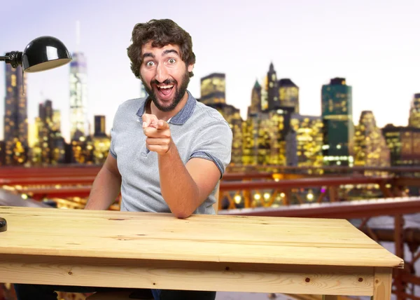 Crazy man at table with surprised expression — Stock Photo, Image