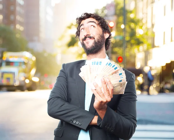 Crazy businessman with banknotes — Stock Photo, Image