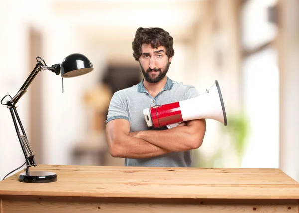 stock image crazy man at table with megaphone