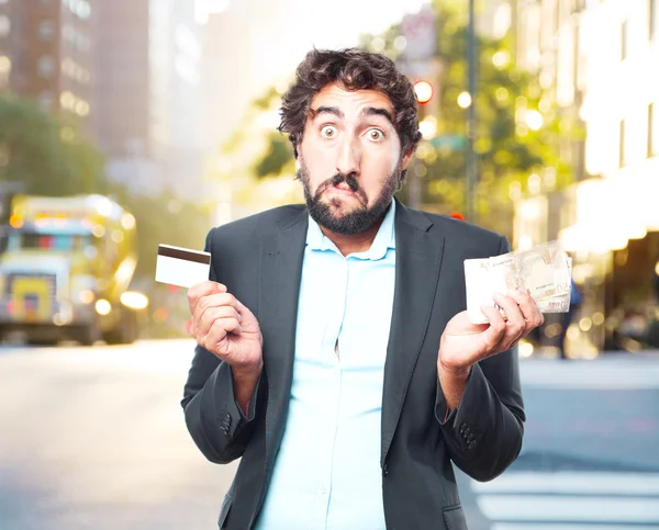 Crazy businessman with banknotes and credit card — Stock Photo, Image