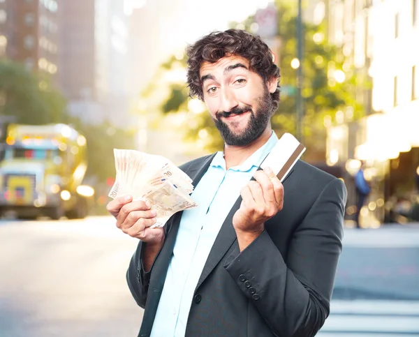 Crazy businessman with banknotes and credit card — Stock Photo, Image