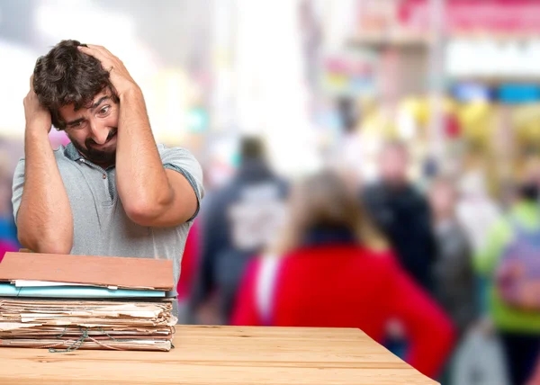 Crazy man at table with documents — Stock Photo, Image