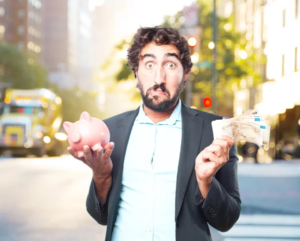 Crazy businessman with banknotes and piggybank — Stock Photo, Image