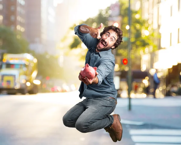 Man jumping with piggybank — Stock Photo, Image