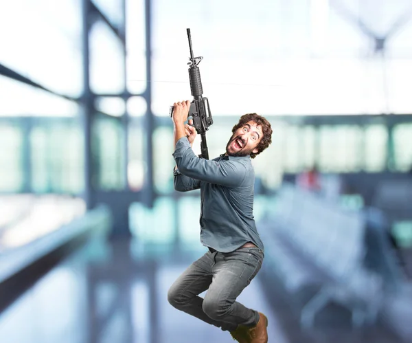 Loco saltando con la pistola — Foto de Stock