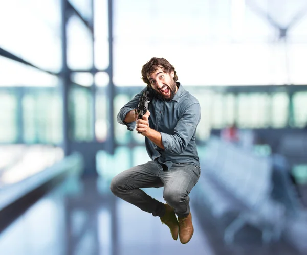 crazy man jumping with gun