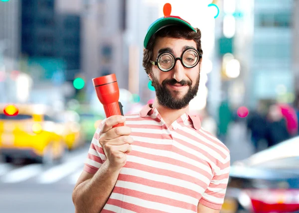Crazy young man with flashlight — Stock Photo, Image
