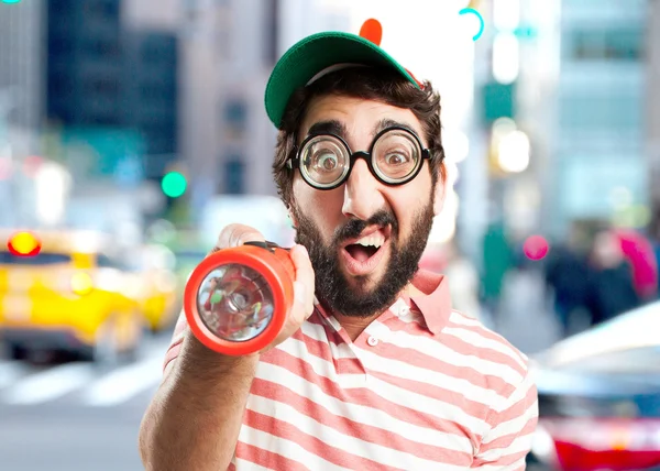 Crazy young man with flashlight — Stock Photo, Image
