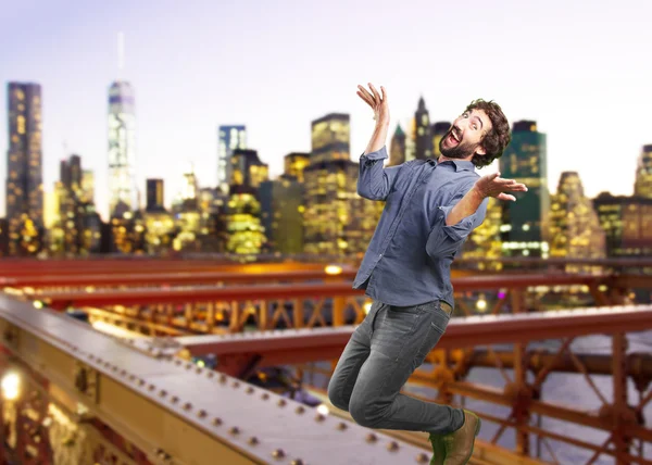 Crazy man jumping with surprised expression — Stock Photo, Image