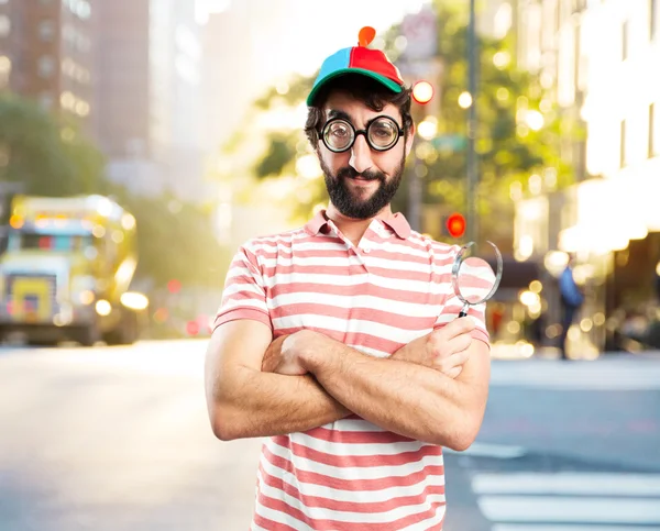 Fool crazy man with magnifying glass — Stock Photo, Image