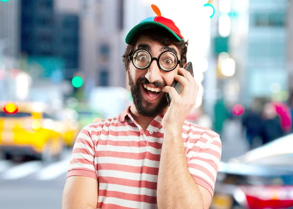 Crazy young man with mobile phone — Stock Photo, Image