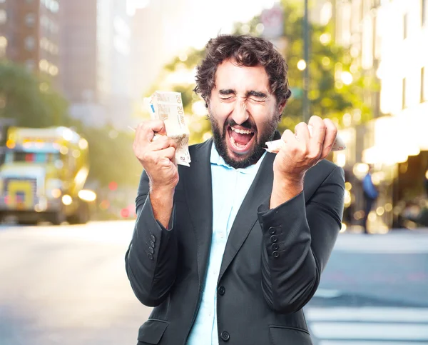 Crazy businessman with banknotes — Stock Photo, Image