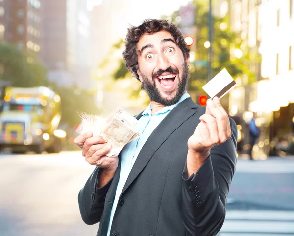 Crazy businessman with credit card and banknotes — Stock Photo, Image