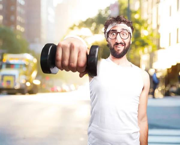 Young crazy sportsman with dumbbell — Stock Photo, Image