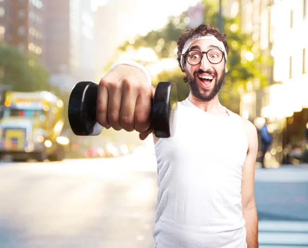 Young crazy sportsman with dumbbell — Stock Photo, Image