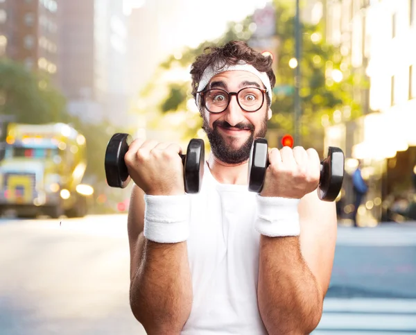 Crazy sportsman with two dumbbells — Stock Photo, Image