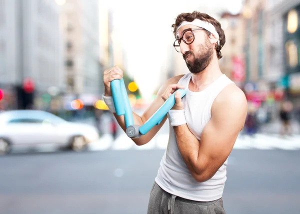 Young crazy sportsman with dumbbell — Stock Photo, Image