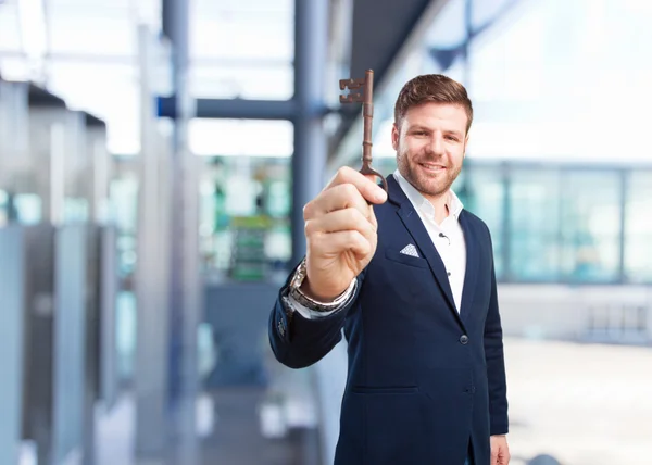 Young happy businessman with key — Stock Photo, Image