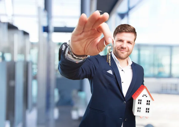 Young businessman with key and toy house — Stock Photo, Image