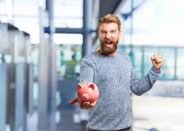 Blonde man with pink piggybank — Stock Photo, Image