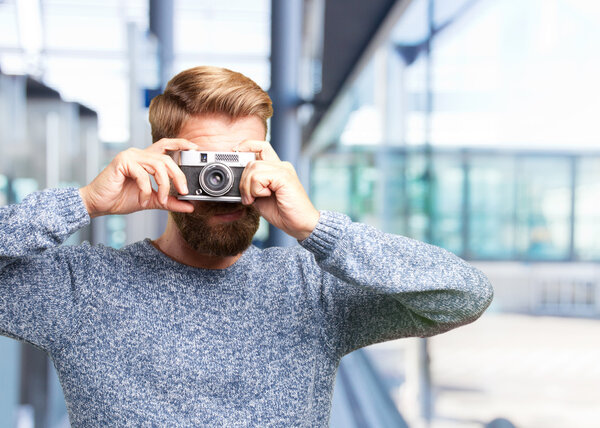 blonde man with retro camera