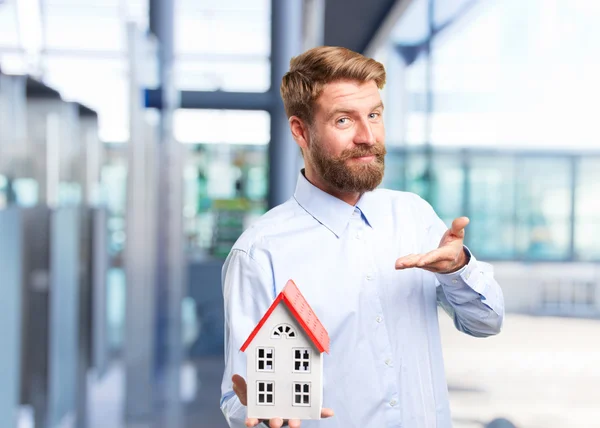 Blond man with toy house — Stock Photo, Image