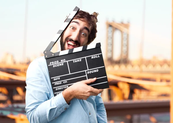 Clapperboard 的年轻快乐商人 — 图库照片