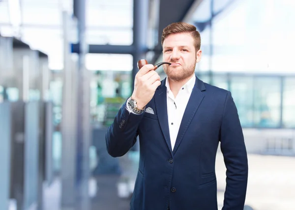 Young businessman with tobacco pipe — Stock Photo, Image
