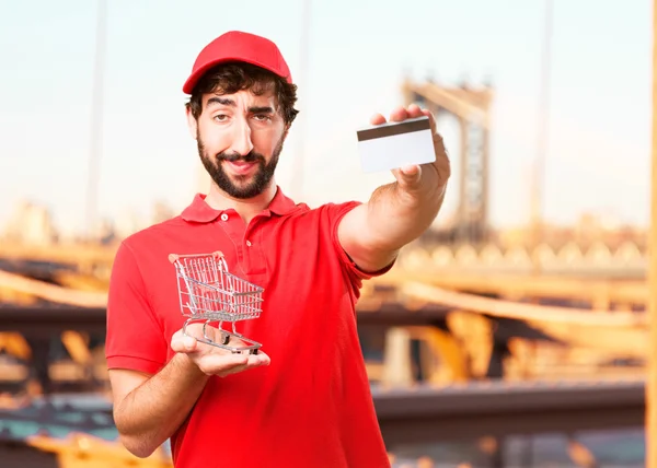 Distribuidor con tarjeta de crédito y carrito de compras —  Fotos de Stock