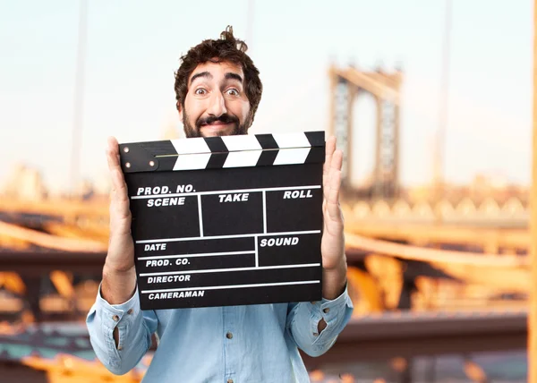 Young happy businessman with clapperboard — Stock Photo, Image