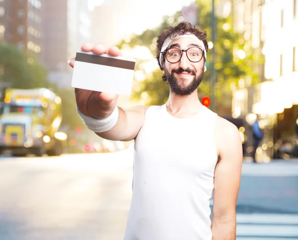 Young crazy sportsman with credit card — Stock Photo, Image