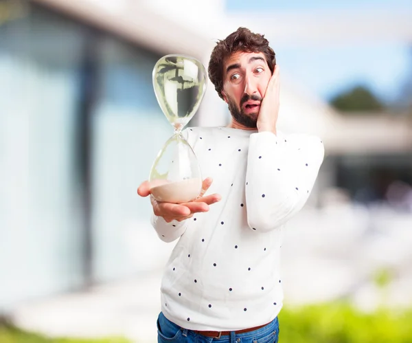 Young crazy man with hourglass — Stock Photo, Image