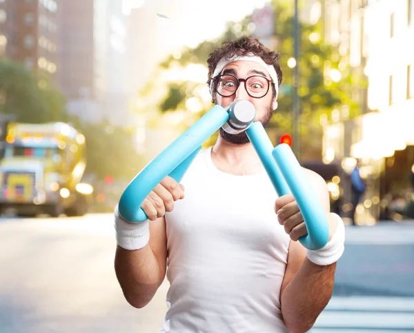 Young crazy sportsman with dumbbell — Stock Photo, Image