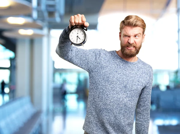 Blond man with alarm clock — Stock Photo, Image