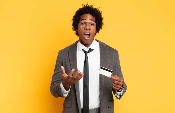 stock image young black afro man looking desperate and frustrated, stressed, unhappy and annoyed, shouting and screaming