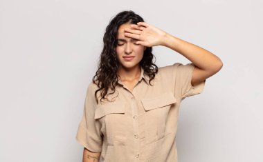 Güzel, genç bir kadın stresli, yorgun ve hayal kırıklığına uğramış görünüyor. Alnından ter akıyor. Umutsuz ve bitkin hissediyor.