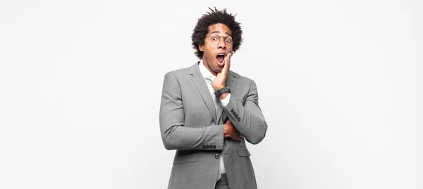 Black Afro Businessmanopen Mouthed Shock Disbelief Hand Cheek Arm Crossed — Stock Photo, Image