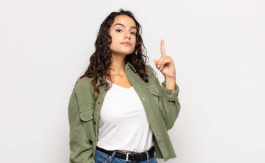 Güzel genç bir kadın, harika bir fikri fark ettikten sonra parmağını havaya kaldırıp 