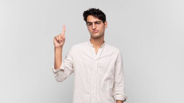 Genç yakışıklı bir adam, harika bir fikri fark ettikten sonra parmağını havaya kaldırıp 