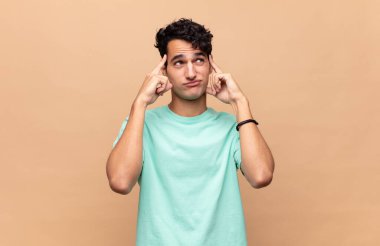 Genç yakışıklı bir adam konsantre olmuş ve bir fikir üzerinde kafa yoruyor, bir meydan okumaya ya da soruna bir çözüm hayal ediyor.