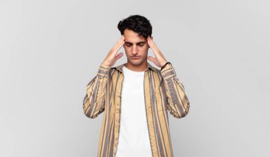 Genç yakışıklı adam konsantre, düşünceli ve ilham verici, beyin fırtınası yapıyor ve hayal kuruyor.