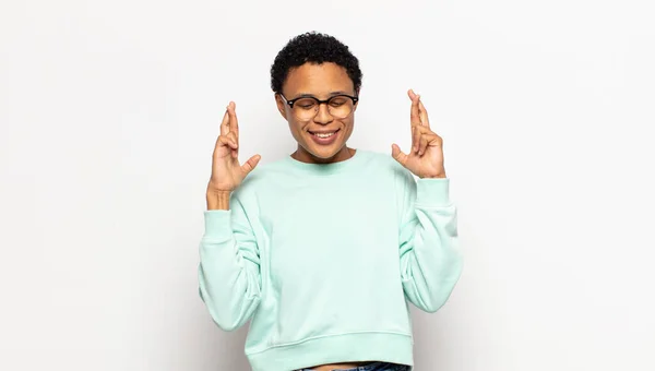 Young Afro Woman Smiling Anxiously Crossing Both Fingers Feeling Worried — Stock Photo, Image